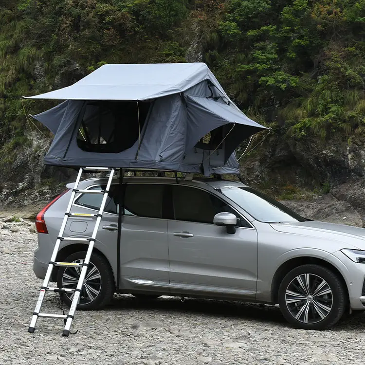Side view of silver SUV with grey soft shell rooftop tent fully deployed, telescopic aluminum ladder attached, exterior camping view.