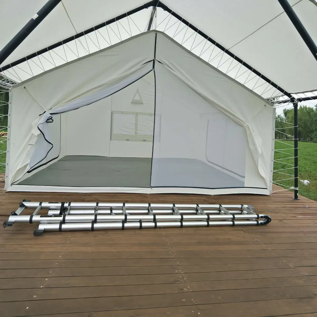 Side view of safari frame tent with ventilation window and black steel frame, white PVC outer cover.